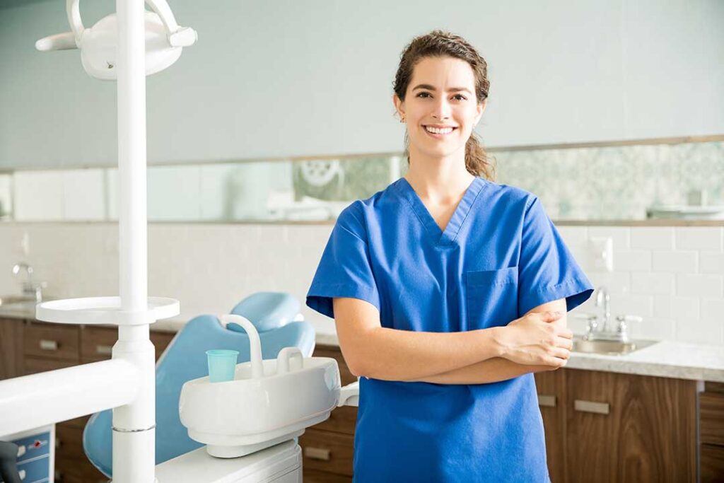 Person gently curving dental floss around a tooth at the gumline in a bright bathroom.
